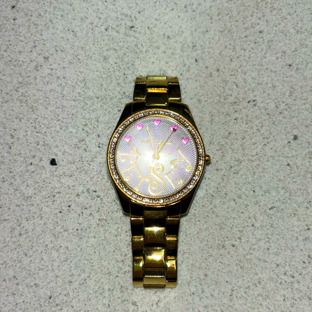 Betsy Johnson women’s gold watch.